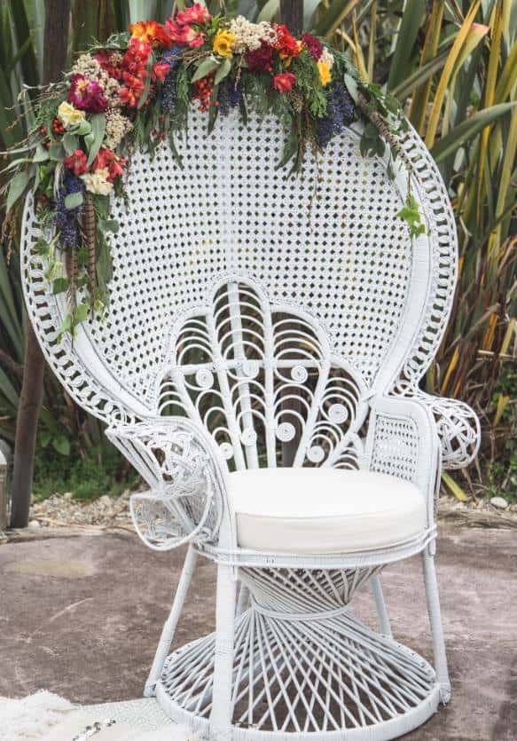 white peacock chair with flowers