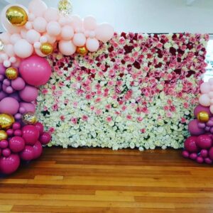 balloons styling around white and pink flower wall