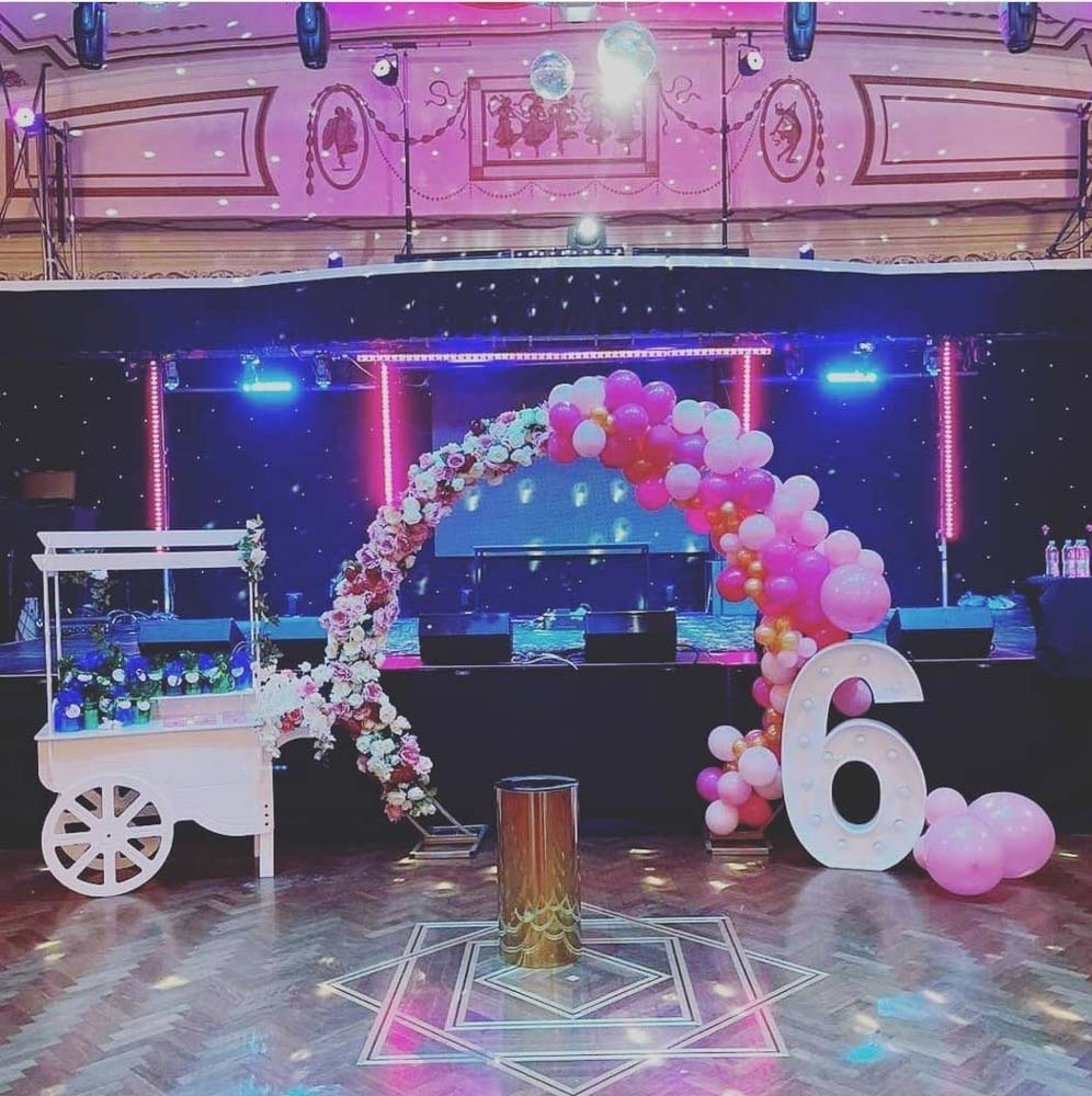 pink and white balloon garland with cart