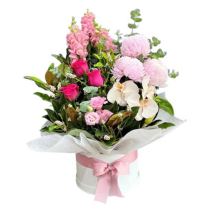 a selection of traditional fresh flowers, roses, snapdragons/stock , mums and phalaenopsis orchid combination