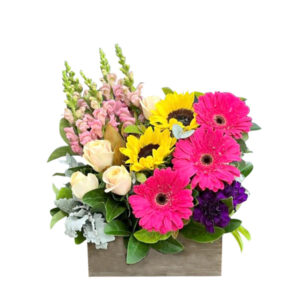 Seasonal flowers, featuring yellow sunflowers at their prettiest and complemented with hot pink and purple gerberas, lisianthus, mini roses and snapdragons