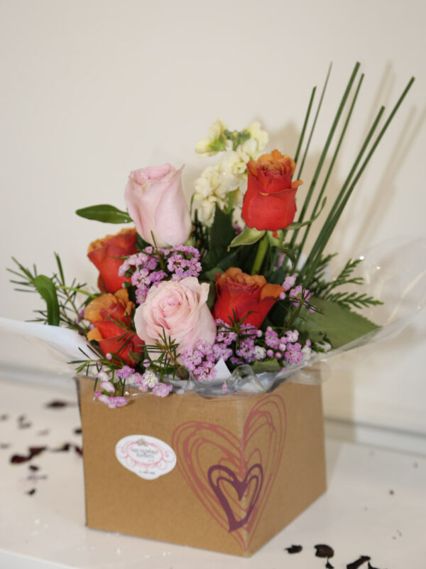 Roses with stock in a cardboard box